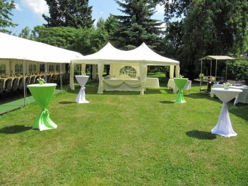 a group of tables in a field with a tent at Hotel Wettin in Treuen