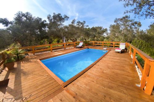 a deck with a swimming pool on top of a house at Villa Astrea in Andrano