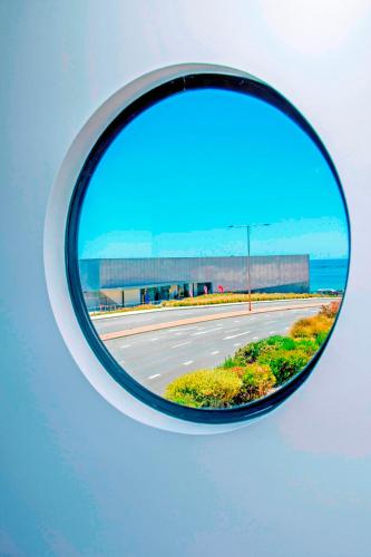 a side mirror of a car with a view of a road at Burnie by the Bay Apartments in Burnie