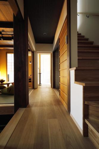 a hallway of a house with wooden floors and stairs at No.10 Kyoto House in Kyoto
