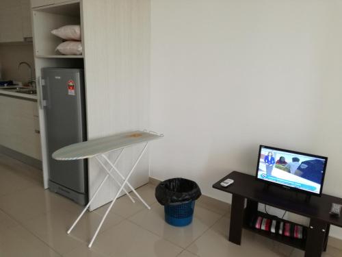 a kitchen with a table and a laptop on a table at i-city i-soho in Shah Alam