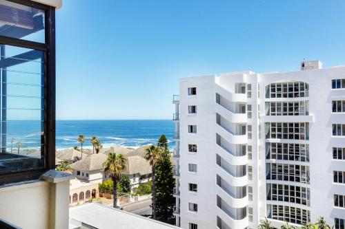 a view of a white building and the ocean at Backup-Powered Bantry Bay View 2 Bed Apartment in Cape Town