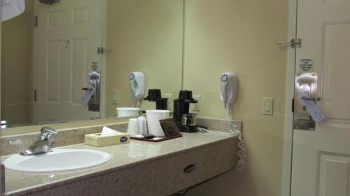 a bathroom with a sink and a mirror at FairBridge Inn & Suites in Leavenworth