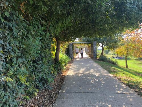 two people walking down a path in a park at The Roof in Kefar Blum