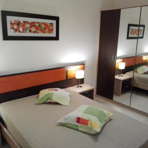 a bedroom with a bed with two pillows on it at Faia Atlantico Apartment in Portimão