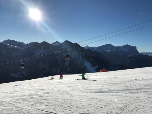 a group of people skiing down a snow covered mountain at Haus Peskoller in Perca