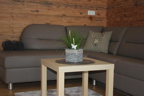 a living room with a couch and a table at Appart Stefanie in Sankt Gallenkirch