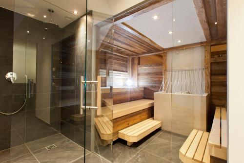 a bathroom with a sauna with a glass shower at Alte Mühle in Nauders