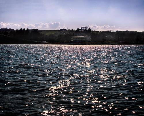 a large body of water with lights on it at Hotel Achillion in Makrýgialos