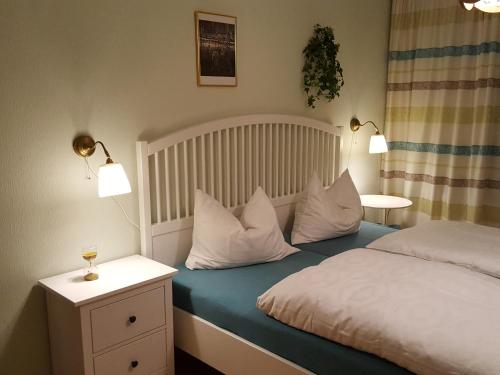 a bedroom with a bed with white sheets and pillows at Ferienwohnung Valentin in Grossarl