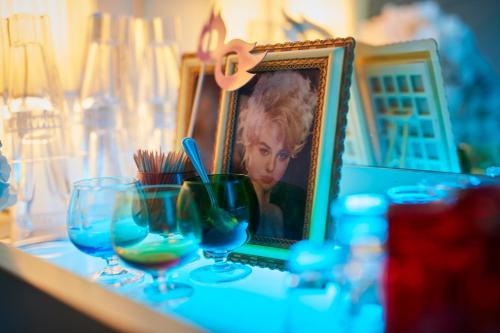 a table with glasses and a picture of a boy at MAISON MARSIL - Boutique Hotel Köln in Cologne