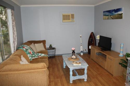 a living room with a couch and a coffee table at Jbay beach shack in Jurien Bay