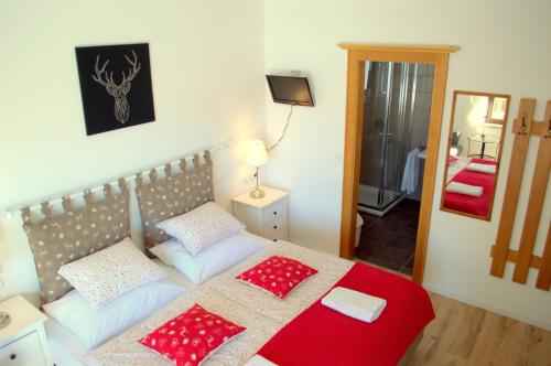 a bedroom with a bed with red and white pillows at Haus Susanne in Radstadt