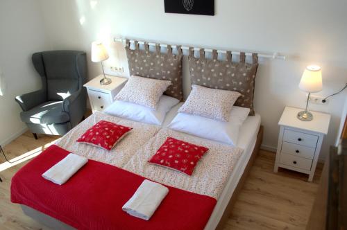 a bedroom with a bed with red and white pillows at Haus Susanne in Radstadt