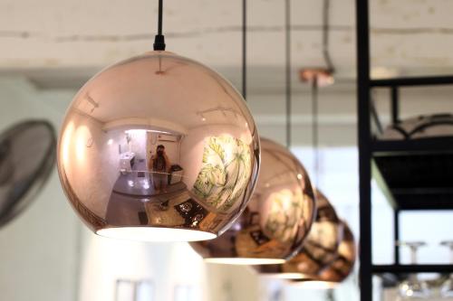 a large glass ball hanging from a ceiling at Stay SongSong Beach Street in George Town