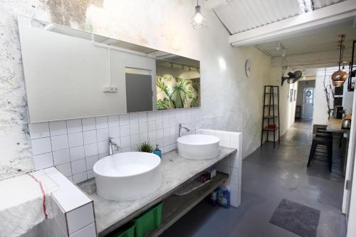 a bathroom with two sinks and a mirror at Stay SongSong Beach Street in George Town