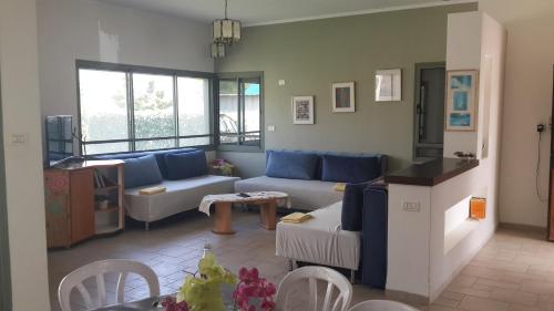a living room with a couch and a table at Holiday home in Galilee in Sheʼar Yashuv