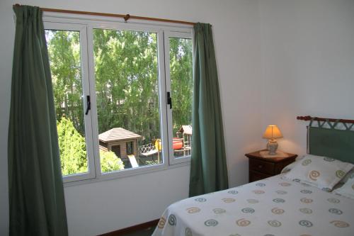 a bedroom with a bed and a large window at Valeria Cielo in Valeria del Mar