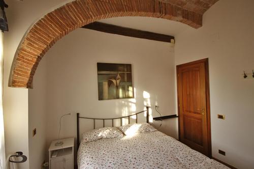 a bedroom with a bed with an arch above it at Campo Al Lupo in Livorno