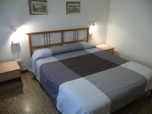 a bedroom with a large bed and two night stands at Appartamento Daniele in Mestre