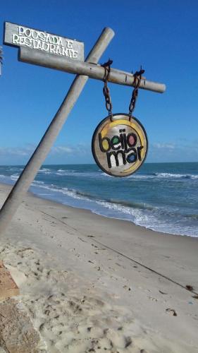 a street sign on the beach next to the ocean at Beijo Mar Beach Club in Tibau