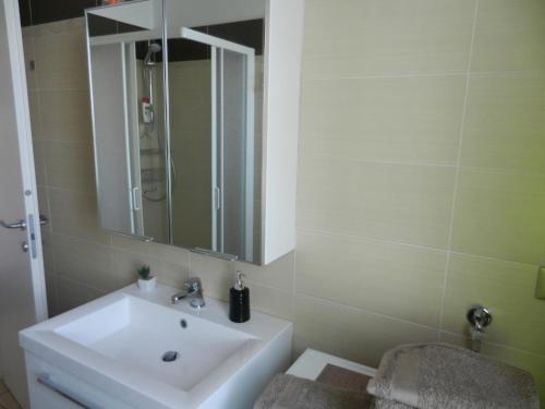 a bathroom with a sink and a mirror at Casa Domenica - 200m dal mare in Ceriale