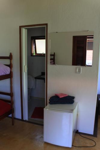 a room with a mirror and a room with a bed at Pousada O Canto das Sereias in Trindade