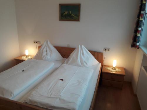 a bedroom with a bed with two lamps on tables at Ferienwohnung Kupfer in Göstling an der Ybbs