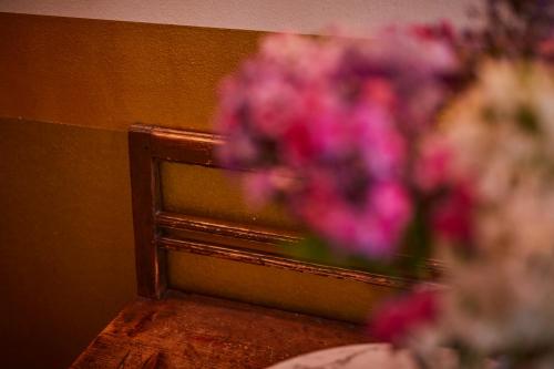 a vase of pink flowers sitting on a table at MAISON MARSIL - Boutique Hotel Köln in Cologne