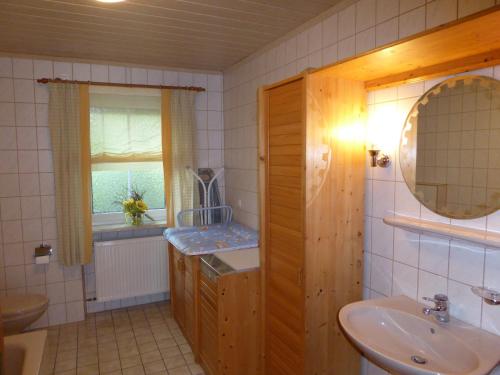 a bathroom with a sink and a mirror at Ferienhof Hübner in Bad Berneck im Fichtelgebirge