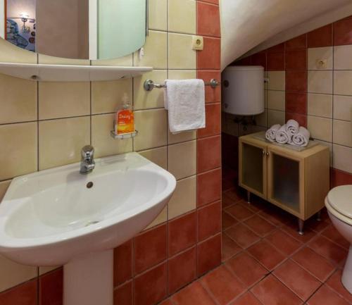 a bathroom with a sink and a toilet at Leonarda in Crikvenica
