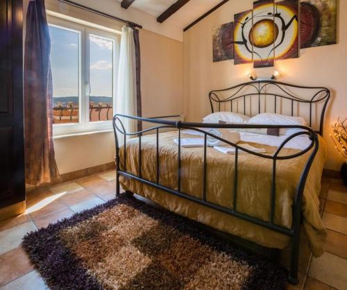 a bedroom with a bed and a window and a rug at Leonarda in Crikvenica