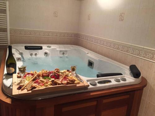 a hot tub with a bunch of food in it at Villamerica in Miskolctapolca