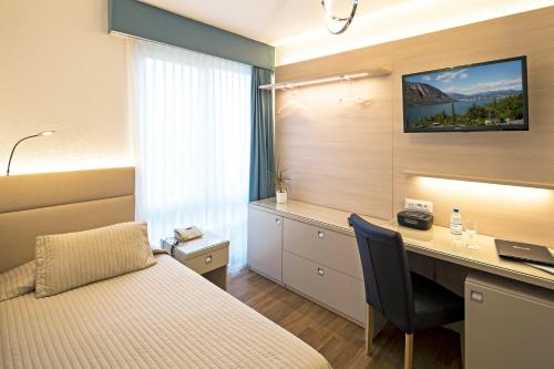 Ένα ή περισσότερα κρεβάτια σε δωμάτιο στο Hotel Campione