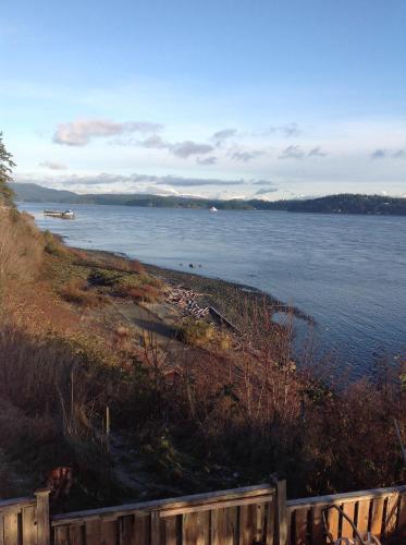 a view of a body of water with a fence at Above Tide Motel in Campbell River