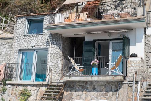 a house with two chairs on a balcony at L'Oblò in Massa Lubrense