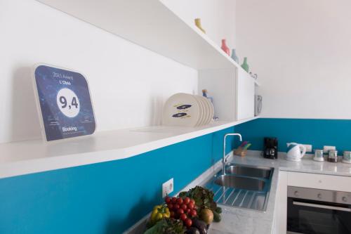 a kitchen with a sink and some fruit on the counter at L'Oblò in Massa Lubrense