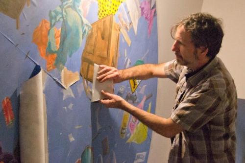 a man is pointing at a box on a wall at Culture Hotel Centro Storico in Naples