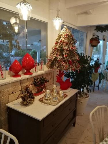 a room with a christmas tree on a dresser at Agriturismo Salinola in Ostuni