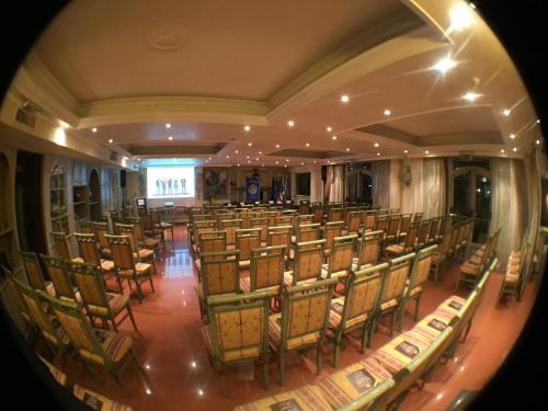 a room with a bunch of chairs and a stage at Hotel Vandelli in Pavullo nel Frignano