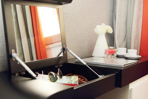 a vanity with a mirror and a sink in a room at Culture Hotel Centro Storico in Naples