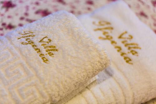 a close up of two white towels with writing on them at Villa Ifigenia in Prinés