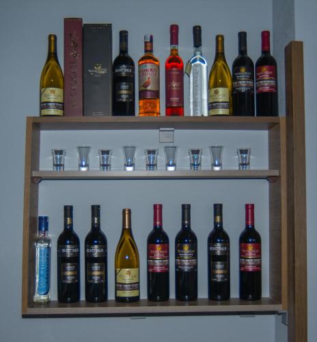 a shelf filled with lots of bottles of wine at Hotel Nabadi in Tbilisi City