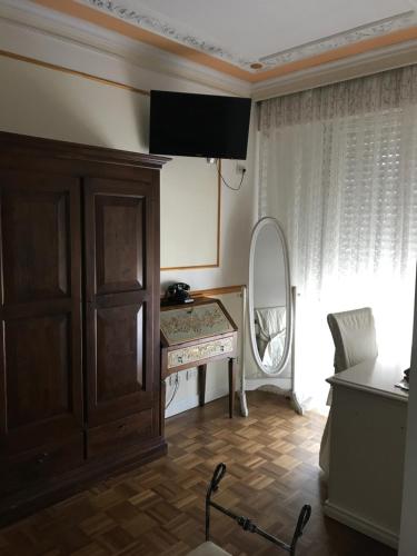 a room with a dresser and a mirror at Hotel Vandelli in Pavullo nel Frignano