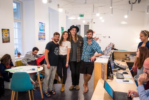 a group of people standing in an office at Avenue Hostel in Budapest