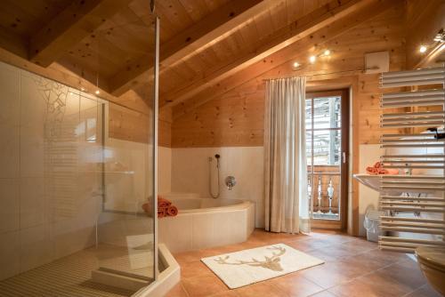 a bathroom with a shower and a bath tub at Oberschupferhof in Außervillgraten