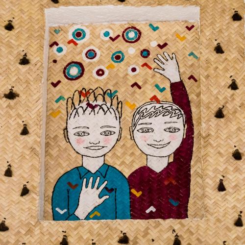 a drawing of two boys on a quilt at NaNa Vida Hotel Oaxaca in Oaxaca City