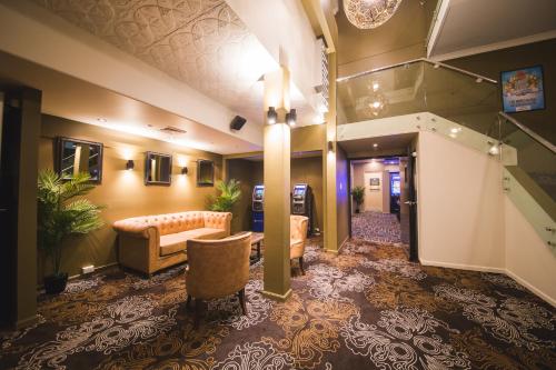 a lobby of a hotel with a couch and chairs at Heritage Hotel Rockhampton in Rockhampton