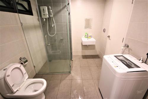 a bathroom with a shower and a toilet and a sink at Solstice Service Apartment CYBERJAYA WiFi Netflix KLIA in Cyberjaya