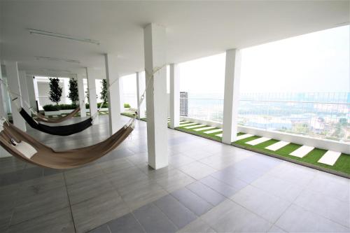 a room with two hammocks in a building at Solstice Service Apartment CYBERJAYA WiFi Netflix KLIA in Cyberjaya